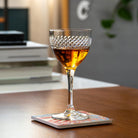 Rolf Glass Diamond 5oz Nic & Nora Classic Cocktail Glass with bourbon on a coffee table