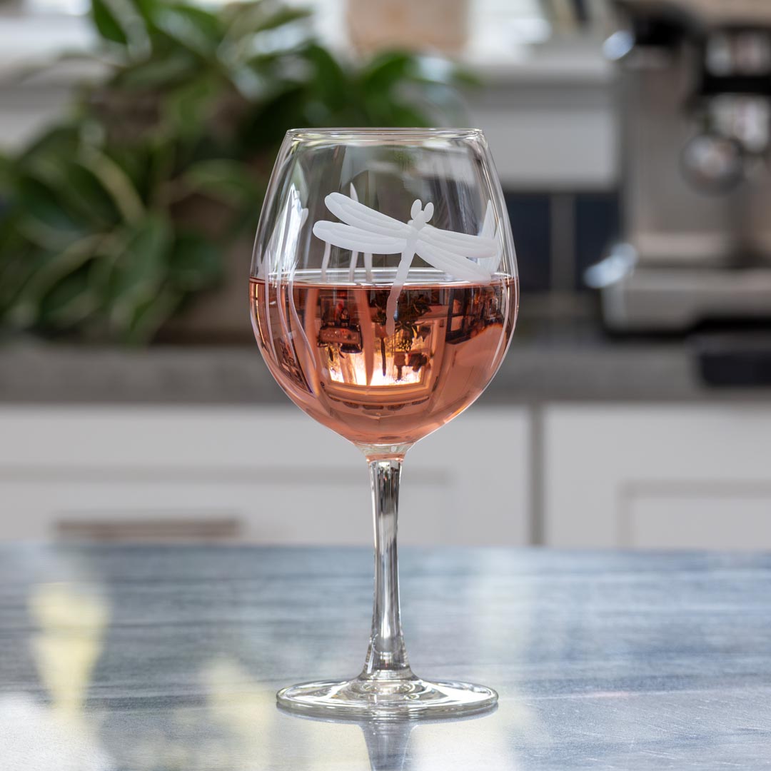 Rolf Glass Dragonfly 18oz Balloon Red Wine Glass filled with red wine on a kitchen counter top