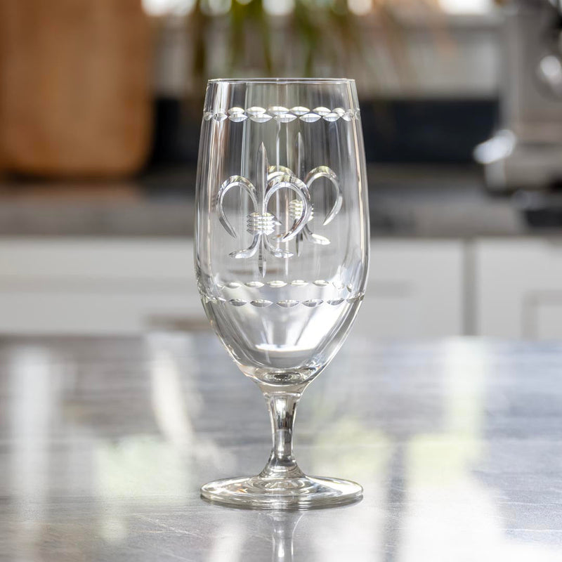 Rolf Glass Fleur De Lis 16oz Footed Iced Tea Glass on a kitchen counter
