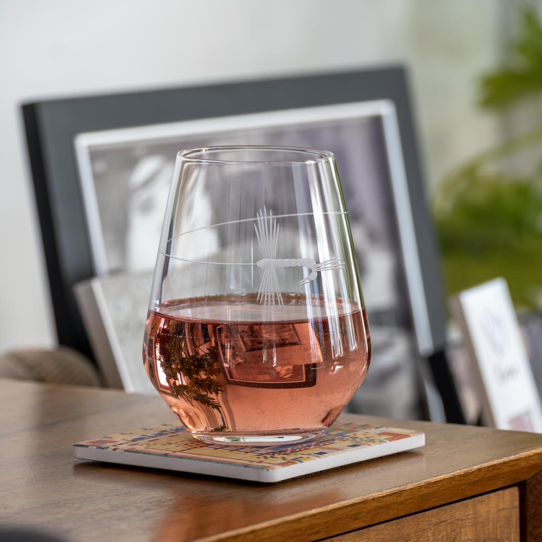 Rolf Glass Fly Fishing 18oz Stemless Wine Tumbler Glass on a wooden desk