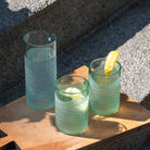 Rolf Glass Glacier Glass 16oz Pitcher and 12oz Tumblers Recycled Reused Repurposed Glassware Sets on the patio