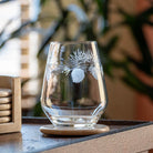 Rolf Glass Icy Pine 18oz Stemless Wine Glass on an end table