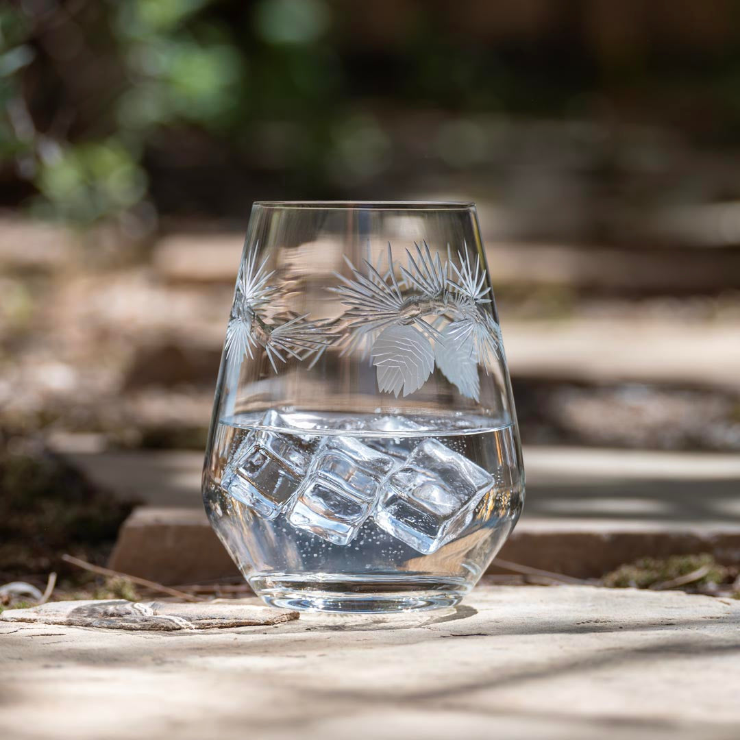 Rolf Glass Icy Pine 18oz Stemless Wine Glass on the patio with ice