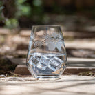 Rolf Glass Icy Pine 18oz Stemless Wine Glass on the patio with ice