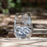 Rolf Glass Icy Pine 18oz Stemless Wine Glass on the patio with ice