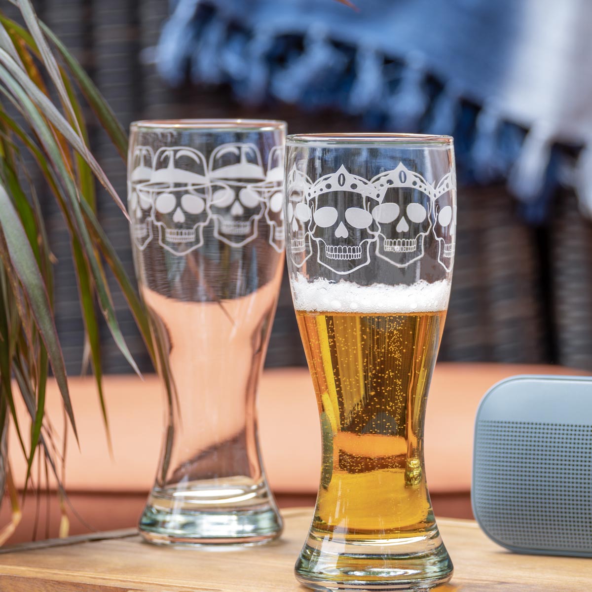 Rolf Glass Numbskulls 20oz Large Pilsner Beer Glass skull wearing crown and skull wearing fedora on the patio