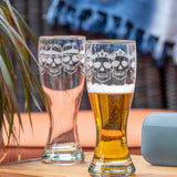 Rolf Glass Numbskulls 20oz Large Pilsner Beer Glass skull wearing crown and skull wearing fedora on the patio