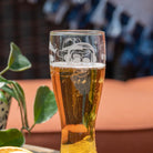 Rolf Glass Numbskulls 20oz Large Beer Pilsner Glass showing detailed engraving of skill with beats headphones on the deck