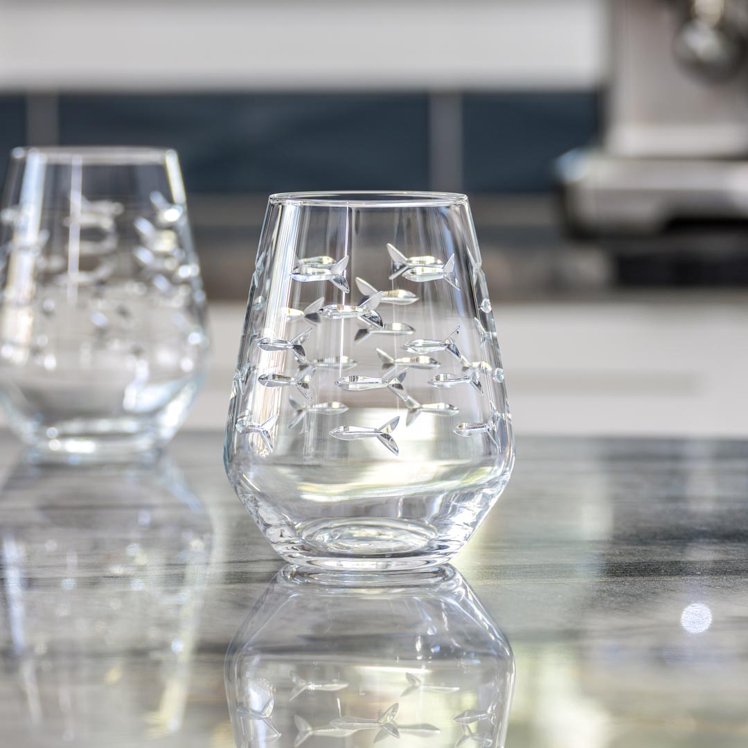 Rolf Glass School of Fish 18oz Stemless Wine Tumbler Glass empty on a granite kitchen counter