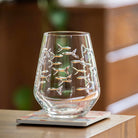 Rolf Glass School of Fish 18oz Stemless Wine Tumble Glass on a desk