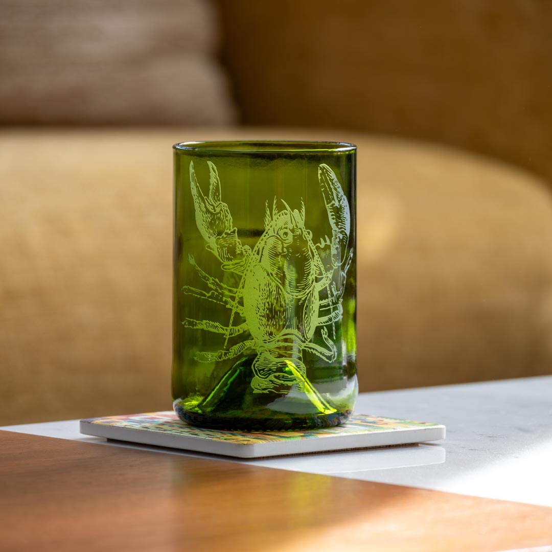 Upcycled Lola Lobster 12oz Dark Green Repurposed Tumbler on a coffee table by Rolf Glass