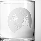 Rolf Glass Jinx Witch detail photo with a Halloween-themed etching of a witch flying over a haunted house on a whiskey glass